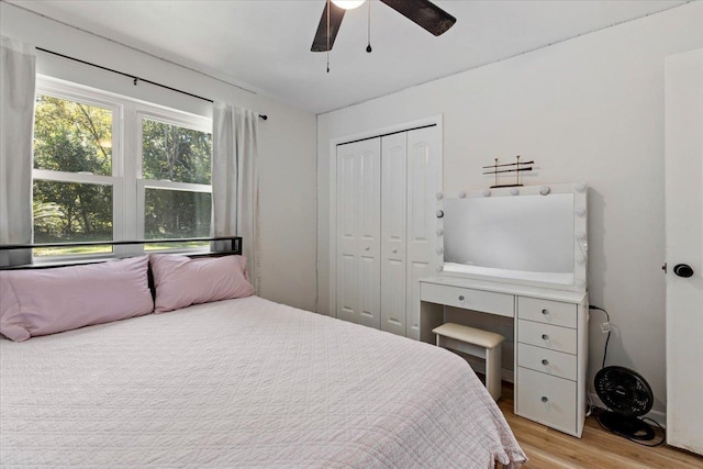 bedroom with ceiling fan, a closet, and light wood-type flooring