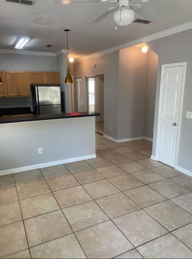 1417 Pullen Rd Unit 101, Tallahassee, FL 32303 - kitchen featuring stainless steel refrigerator, dark countertops, ornamental molding, light tile patterned floors, and ceiling fan