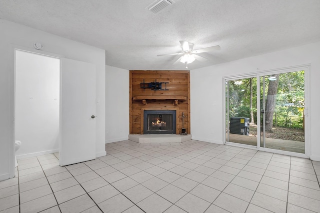 1846 Sylvan Ct, Tallahassee, FL 32303 - unfurnished living room with a large fireplace, ceiling fan, a textured ceiling, light tile patterned floors, and baseboards