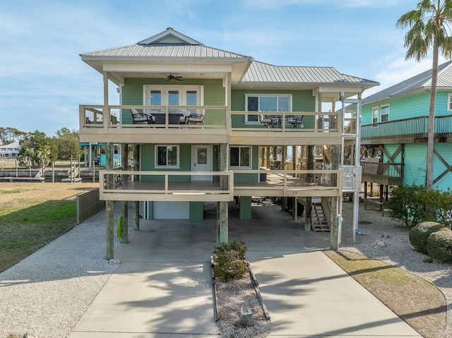 view of front of home with ceiling fan, a balcony, and a carport