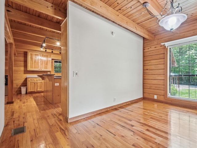 883 Hunters Trce, Crawfordville, FL 32327 - spare room with a wooden ceiling with exposed beams, wood walls, plenty of natural light, and light wood-style flooring