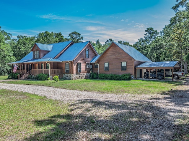 883 Hunters Trce, Crawfordville, FL 32327 - view of front of house featuring covered porch, a front lawn, a carport, a metal roof, and driveway