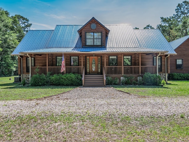883 Hunters Trce, Crawfordville, FL 32327 - log cabin featuring a porch, log exterior, a metal roof, and a front lawn