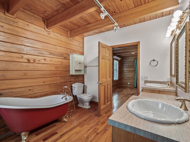 883 Hunters Trce, Crawfordville, FL 32327 - bathroom with a wood ceiling with exposed beams, a freestanding tub, wooden walls, wood finished floors, and double vanity