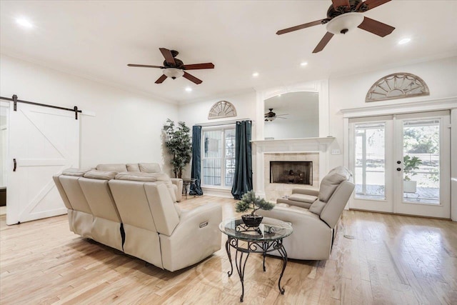 650 Mossy Oak Trl, Tallahassee, FL 32317 - living room with ceiling fan, light wood-style floors, a barn door, a tile fireplace, and recessed lighting