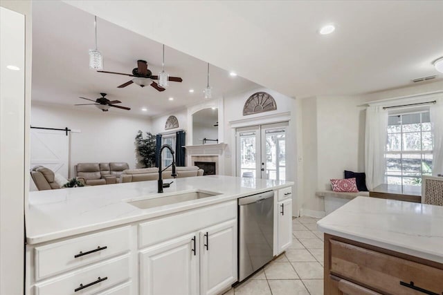 650 Mossy Oak Trl, Tallahassee, FL 32317 - kitchen featuring stainless steel dishwasher, open floor plan, light tile patterned floors, white cabinetry, and a ceiling fan