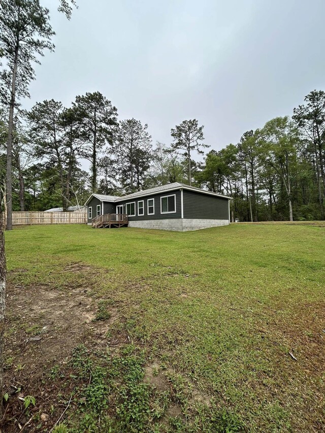view of yard with fence and a wooden deck