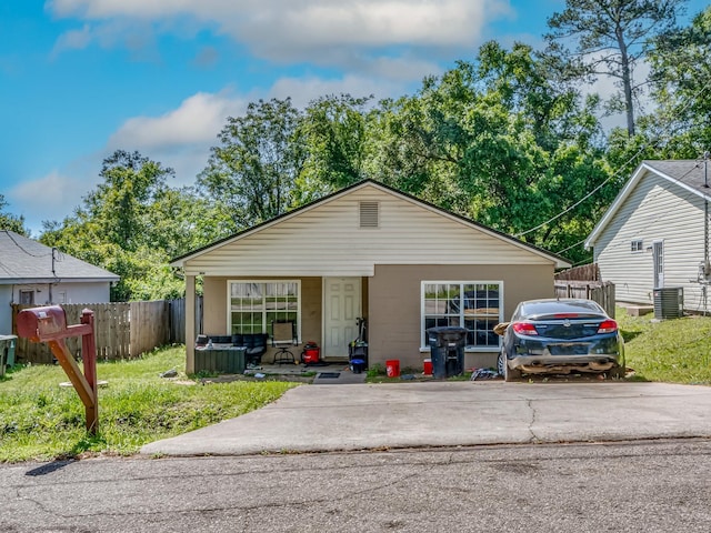 bungalow-style house featuring a porch, central air condition unit, and fence