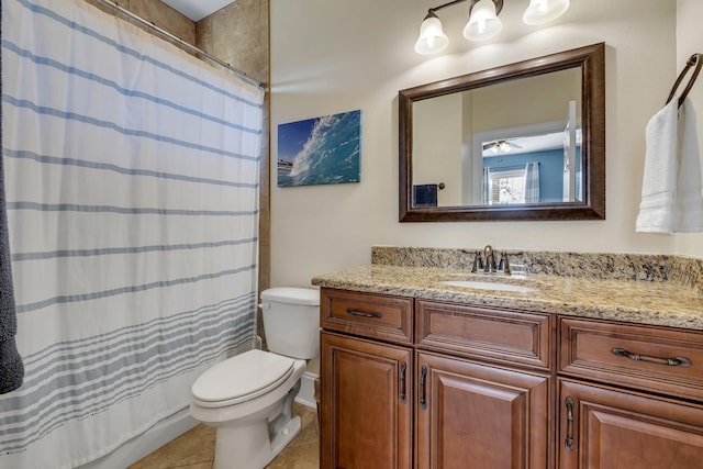 bathroom with a shower with curtain, toilet, vanity, and tile patterned flooring