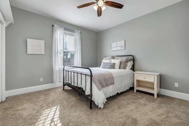 bedroom featuring baseboards, light carpet, and ceiling fan