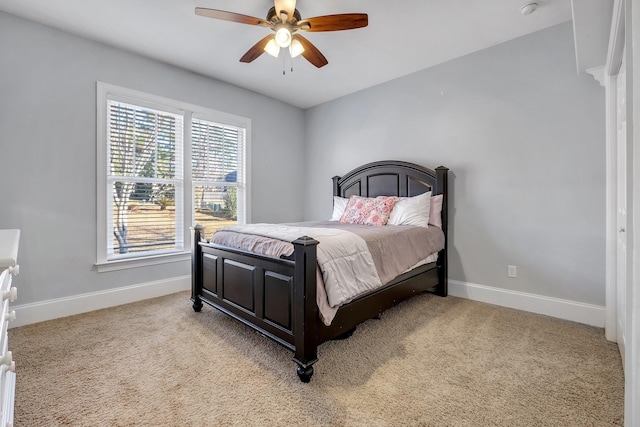 carpeted bedroom with baseboards and ceiling fan