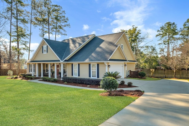 view of front of property with a front lawn, driveway, a porch, fence, and roof with shingles