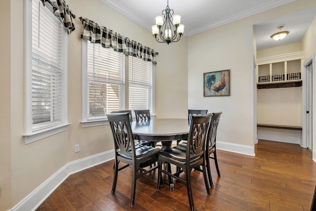 dining space featuring a notable chandelier, ornamental molding, baseboards, and hardwood / wood-style flooring