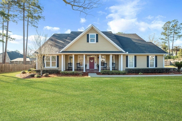 view of front of property with a front yard, a porch, and fence