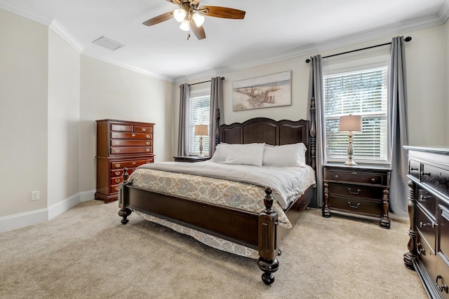 bedroom featuring light colored carpet, crown molding, baseboards, and ceiling fan