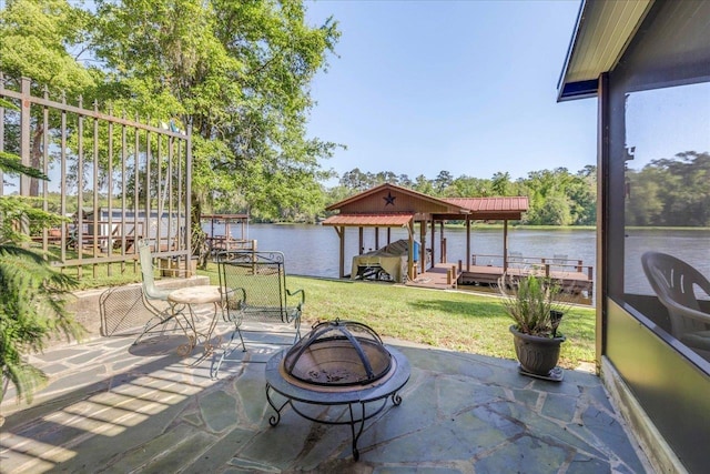 24064 Lanier St, Tallahassee, FL 32310 - view of patio / terrace featuring a water view, a dock, boat lift, and an outdoor fire pit