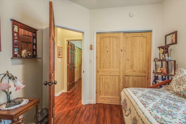 24064 Lanier St, Tallahassee, FL 32310 - bedroom with dark wood-style floors, a closet, and baseboards