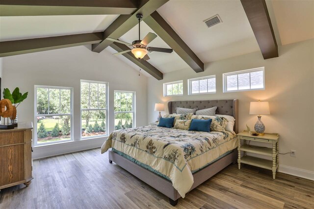 bedroom featuring hardwood / wood-style floors, ceiling fan, multiple windows, and beam ceiling