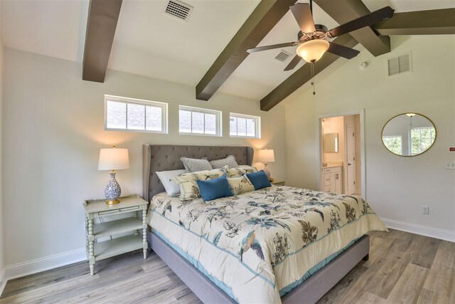 bedroom with ensuite bathroom, lofted ceiling with beams, light hardwood / wood-style flooring, and ceiling fan