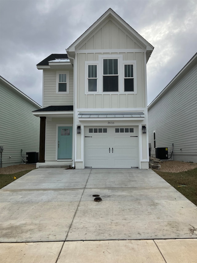 front of property with a garage and cooling unit