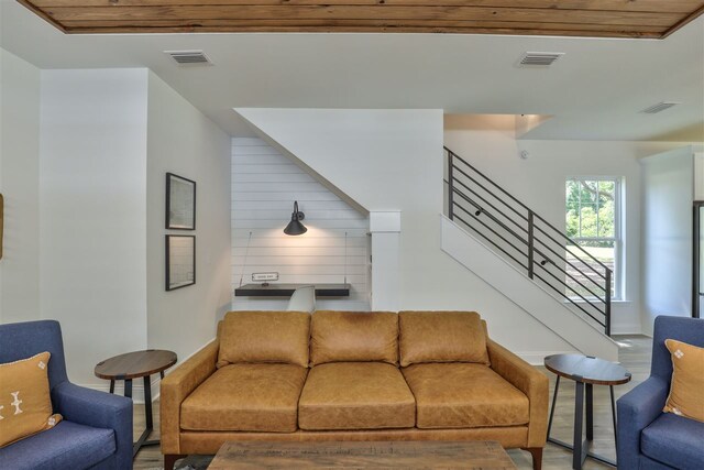 living room with wood walls, wood-type flooring, and wood ceiling