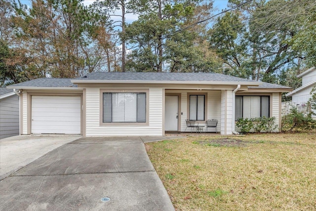 ranch-style home featuring a garage, a front yard, and covered porch