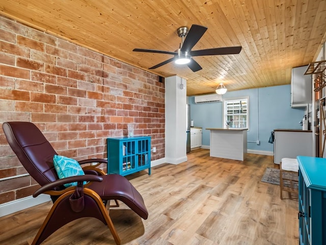 sitting room with ceiling fan, wooden ceiling, brick wall, an AC wall unit, and light wood-type flooring