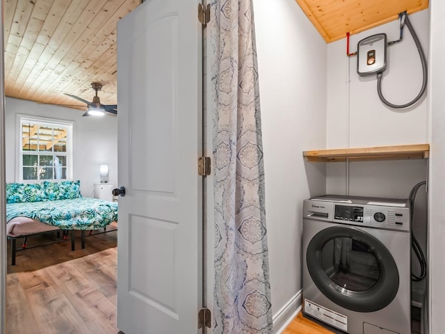 clothes washing area with light wood-type flooring, washer / clothes dryer, ceiling fan, and wooden ceiling