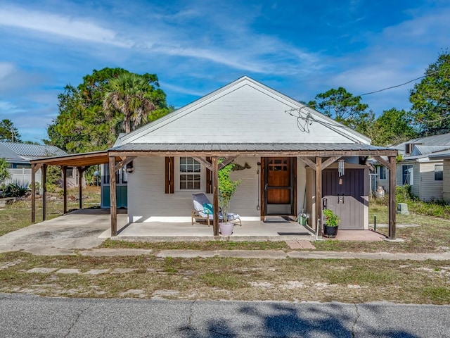 bungalow with a porch and a carport