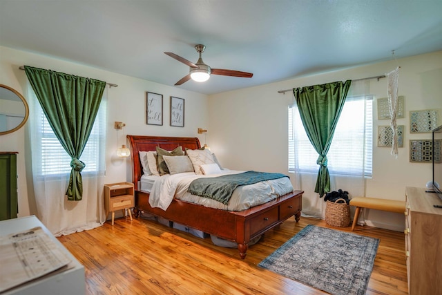 bedroom with ceiling fan and light wood-type flooring