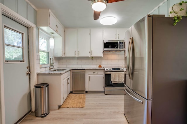 kitchen featuring white cabinetry, sink, decorative backsplash, and appliances with stainless steel finishes