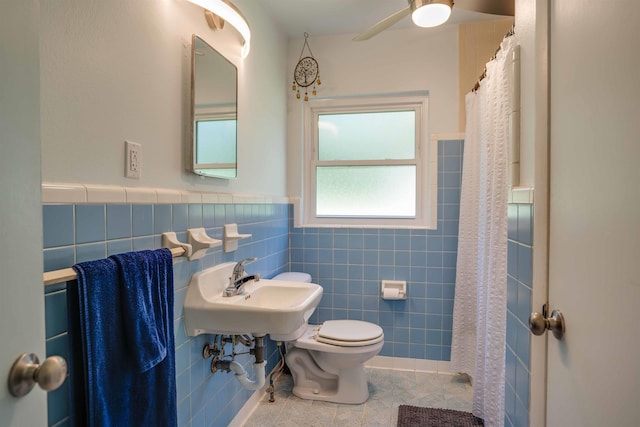 bathroom featuring sink, tile walls, tile patterned flooring, a shower with shower curtain, and toilet