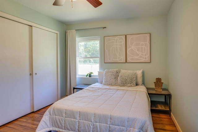 bedroom featuring wood-type flooring, ceiling fan, and a closet