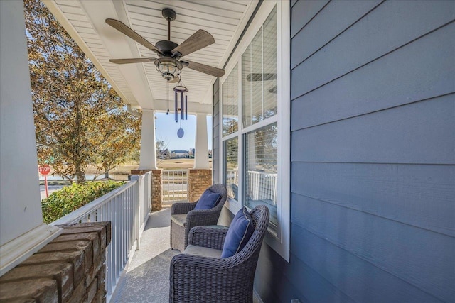 balcony with ceiling fan and a porch