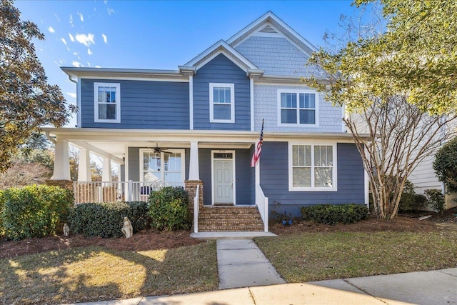 view of front of home with covered porch and a front lawn