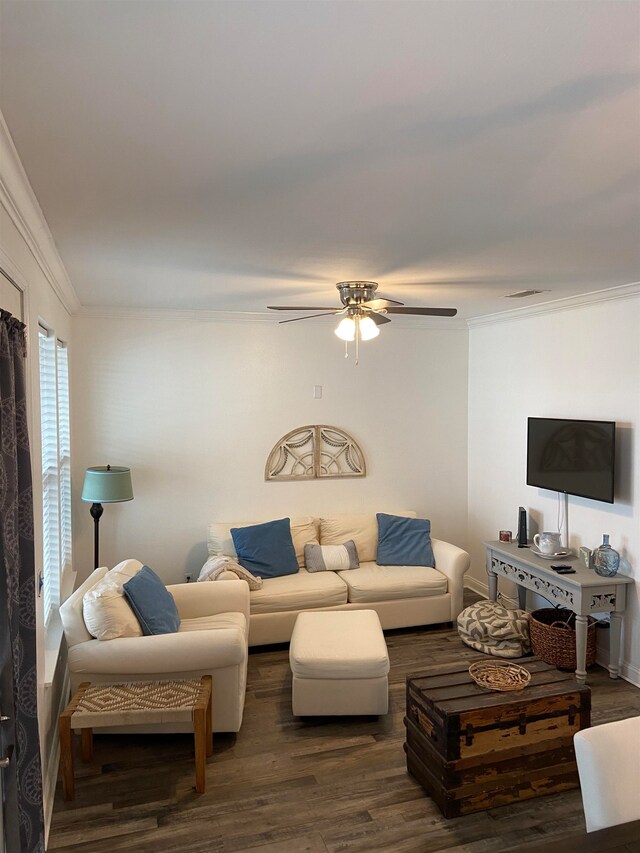 living room with ornamental molding, ceiling fan, and dark hardwood / wood-style floors