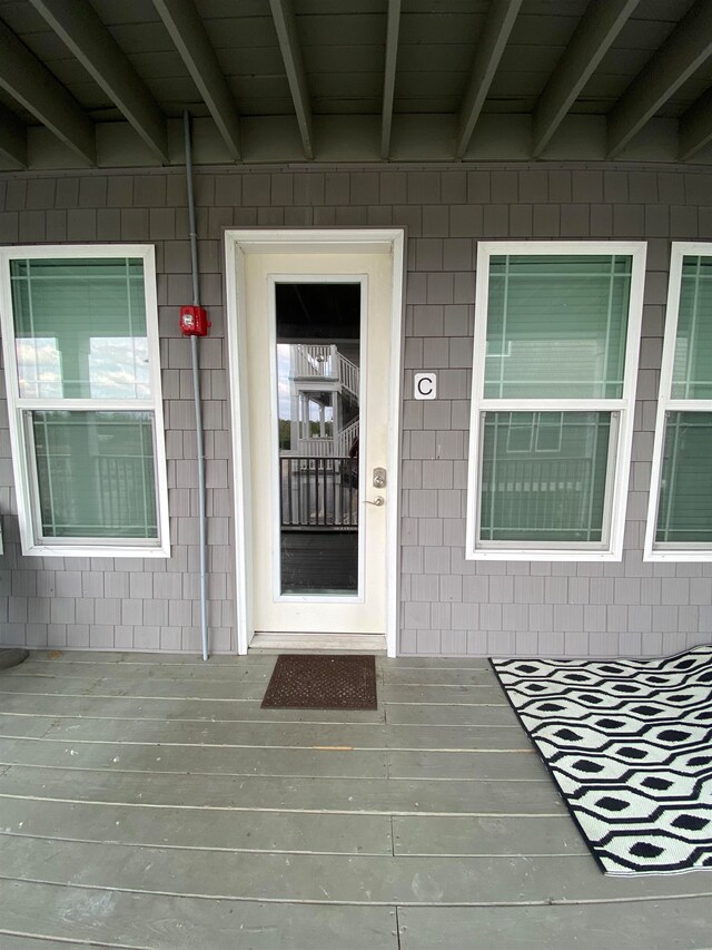 doorway to property featuring a wooden deck