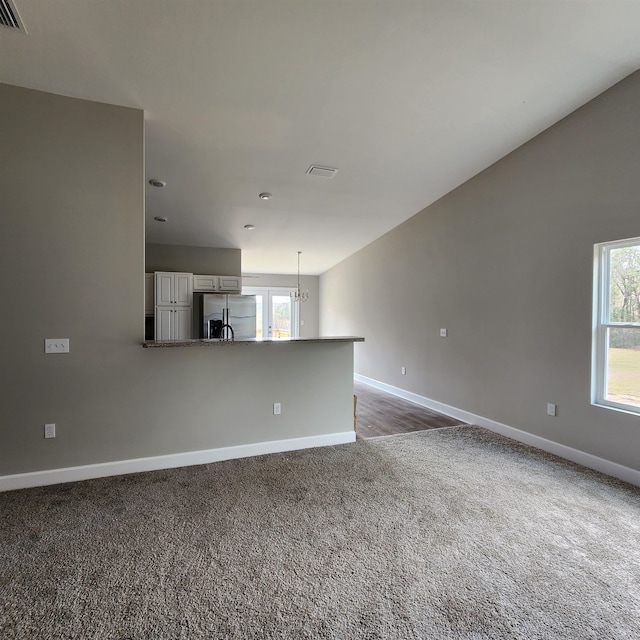 unfurnished living room with carpet flooring