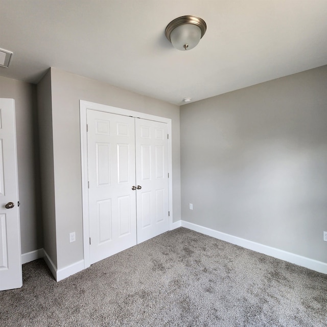 unfurnished bedroom featuring a closet and carpet