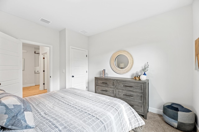 bedroom featuring light colored carpet