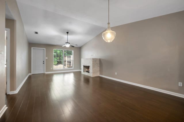 7326 Hollis St, Tallahassee, FL 32312 - unfurnished living room featuring a stone fireplace, a ceiling fan, dark wood-type flooring, and lofted ceiling