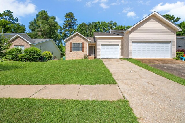 7326 Hollis St, Tallahassee, FL 32312 - view of front of property featuring driveway, a front lawn, brick siding, and an attached garage