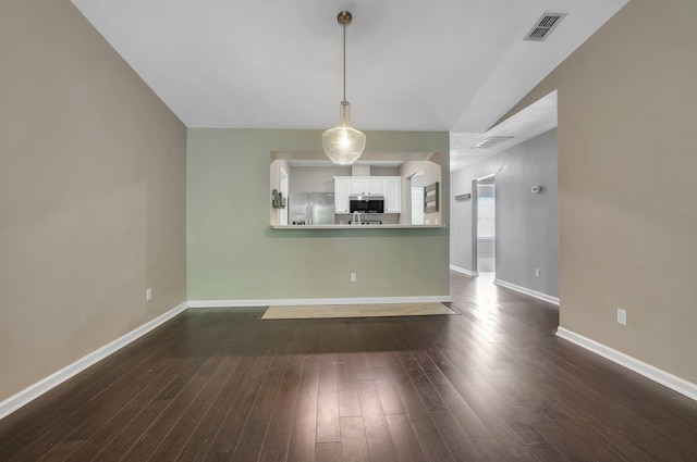 7326 Hollis St, Tallahassee, FL 32312 - unfurnished living room with baseboards and dark wood finished floors