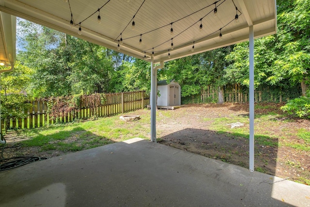 7326 Hollis St, Tallahassee, FL 32312 - fenced backyard with a patio, a storage shed, view of wooded area, and a carport