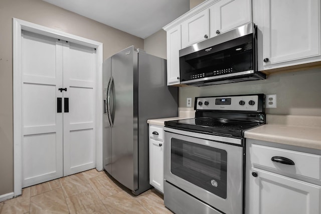 7326 Hollis St, Tallahassee, FL 32312 - kitchen featuring appliances with stainless steel finishes, light countertops, and white cabinetry