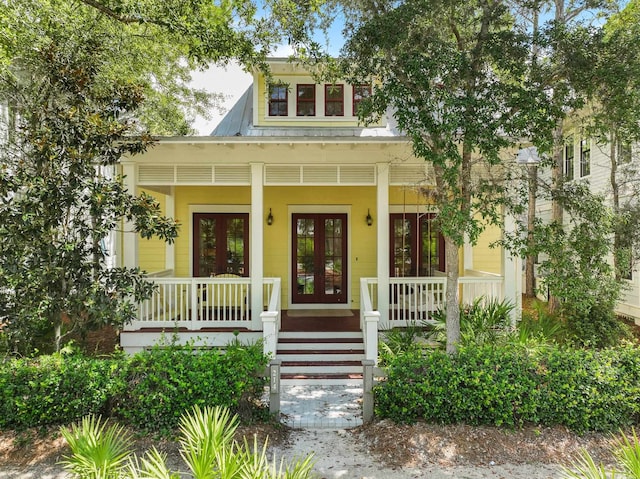 doorway to property featuring covered porch and french doors