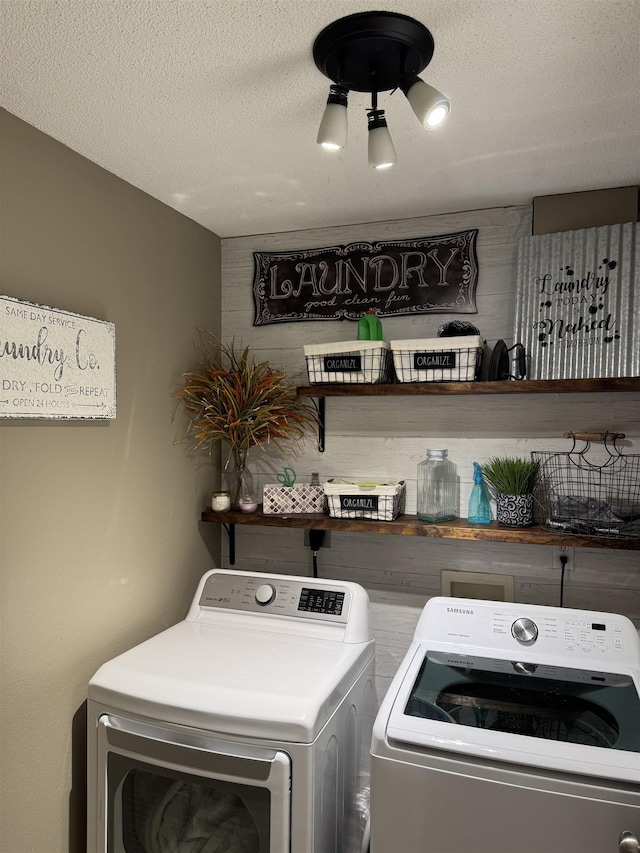 washroom featuring separate washer and dryer and a textured ceiling