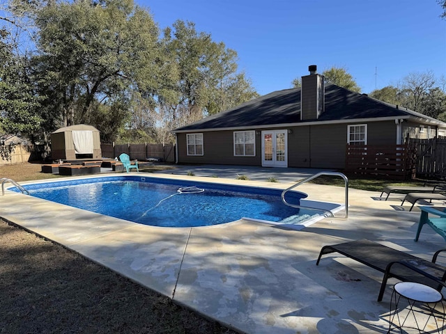 view of swimming pool featuring french doors and a patio