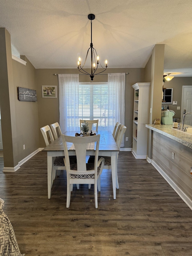 dining area featuring a textured ceiling, a chandelier, and dark hardwood / wood-style floors