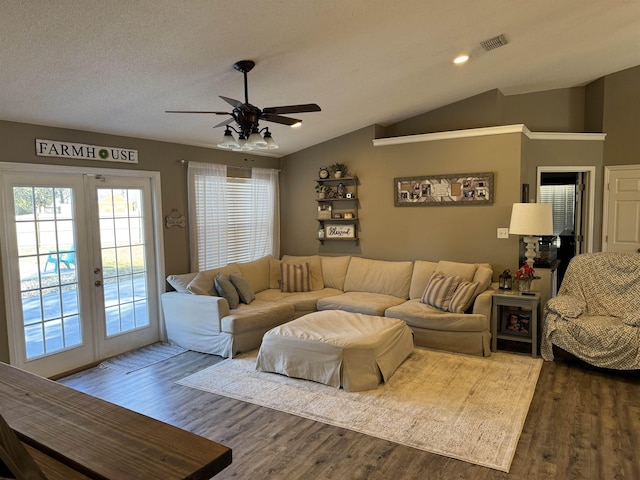 living room featuring a textured ceiling, dark hardwood / wood-style flooring, french doors, vaulted ceiling, and ceiling fan